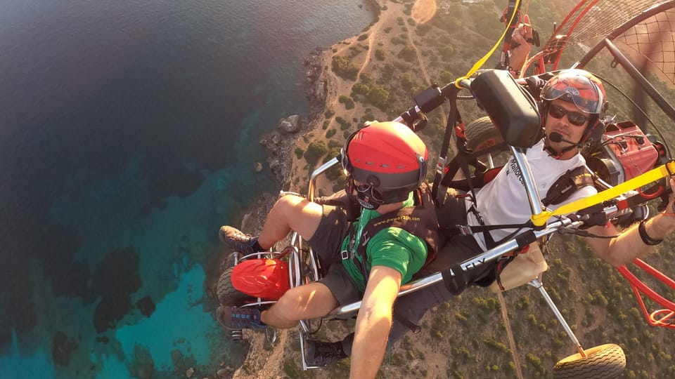 Mallorca: Paratrike Flight with Acrobatics and Engine Stop - Flying above Mallorca’s cliffs in a motorized paraglider setup